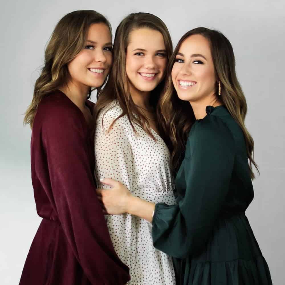 Sophia and sisters posing in 2019.