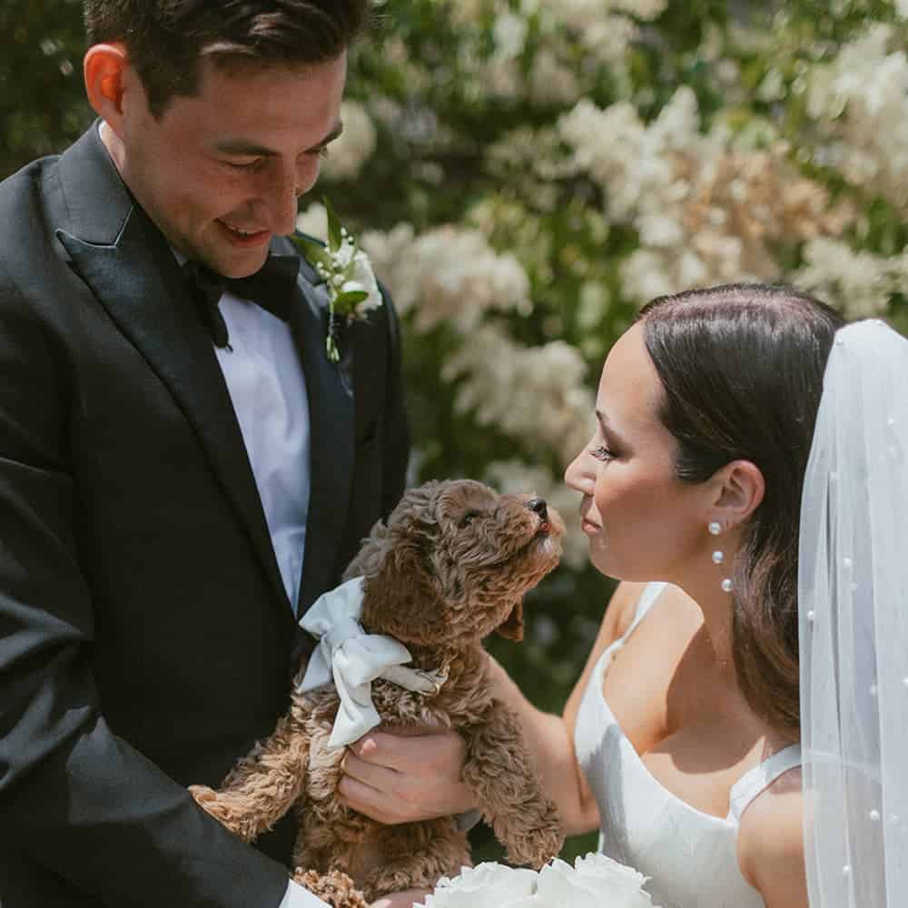 Sophia and Ben at wedding with their dog in 2023.